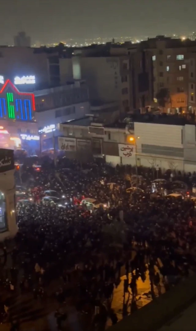 Crowds of people walk through the streets in Tehran