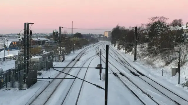Train tracks covered in ice and snow