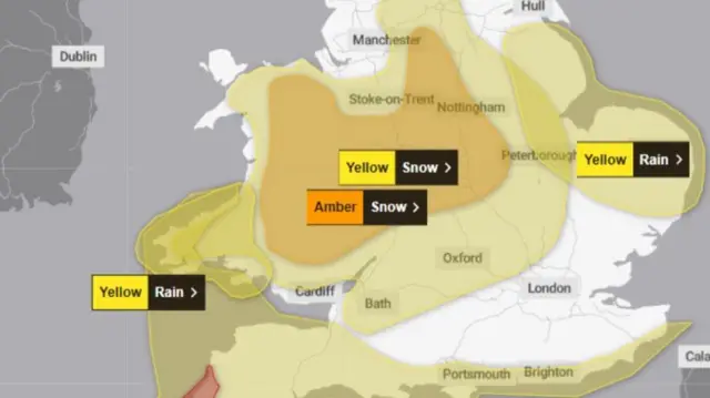 A map shows yellow, amber and red weather warnings across the UK. A red warning for wind is in place in parts of Cornwall while an orange warning for snow covers a horse shoe shape in Wales and the West Midlands
