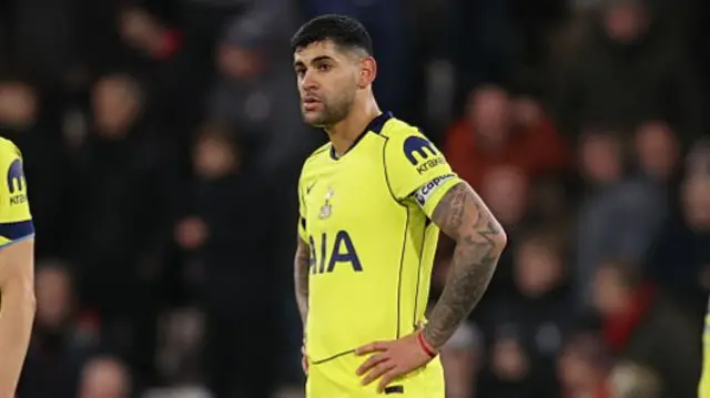 Tottenham captain Cristian Romero with his hands on his hips