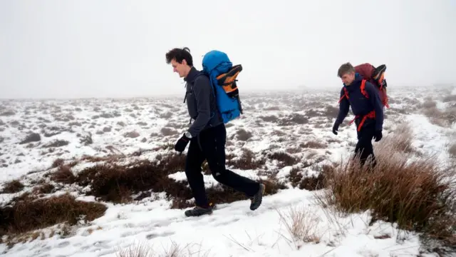 Ice climbers head out from Featherbed Moss in the Peak District as the wintry weather continues in the UK The UK is braced for heavy snowfall and strong winds from Storm Goretti with amber weather warnings issued across the country.
