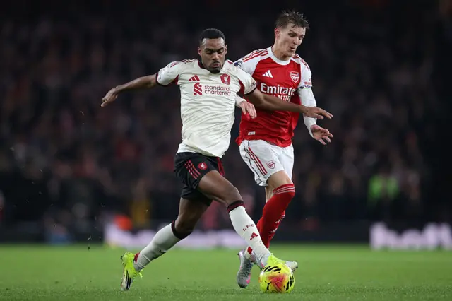 Ryan Gravenberch of Liverpool holds off a challenge from Martin Odegaard