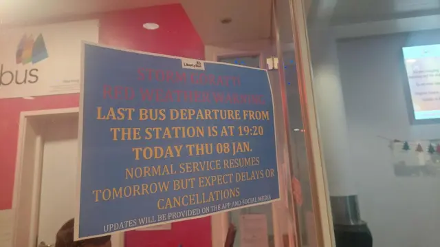 A sign at a station warns that a red weather warning is in place due to Storm Goratti and that the last bus will depart at 19:20 on Thursday