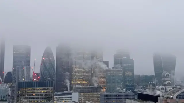 Foggy conditions over London skyline.