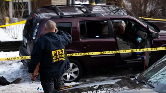Members of law enforcement work the scene following shooting by an ICE agent in Minneapolis, Minnesota