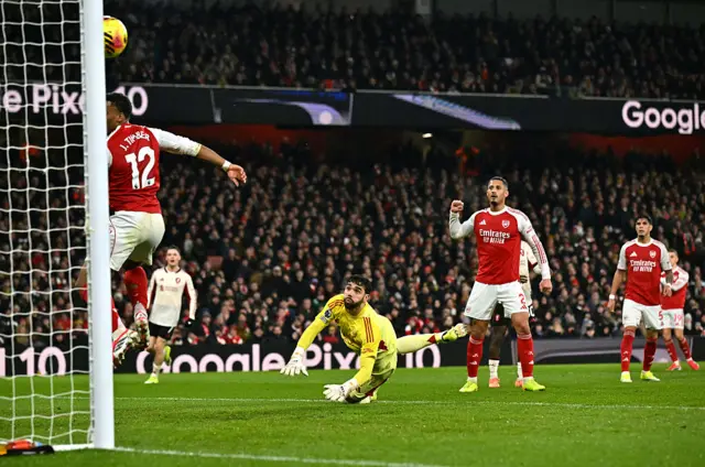 Arsenal's Spanish goalkeeper #01 David Raya (C) looks on as the ball hits the post