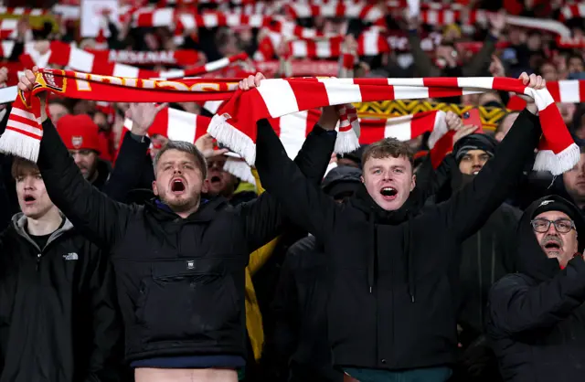 Fans hold scarves aloft prior to the Premier League