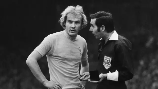 Terry Yorath gets a talking-to from a referee while playing for Leeds