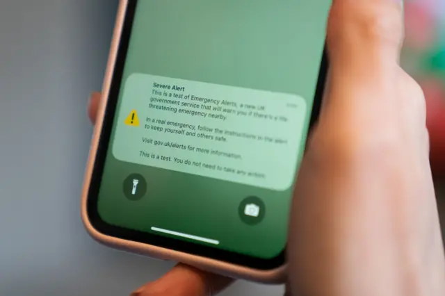 File photo of a test of a public alert system emitting a loud alarm on a mobile phone