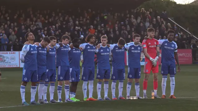 Macclesfield players hold a minute's silence