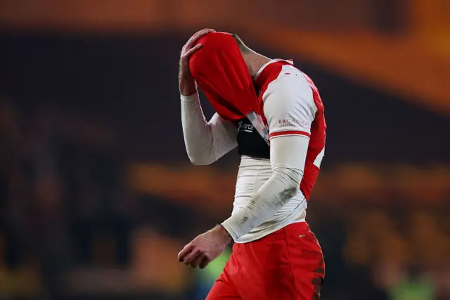 Shaun Rooney has his head in his hands under his shirt