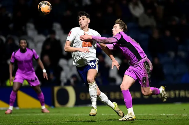 reston North End's Jordan Storey vies for possession with Wigan Athletic's Callum Wright