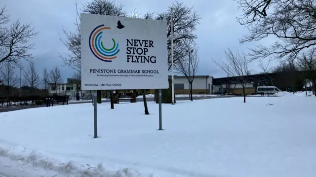 Snowy scene in front of a school