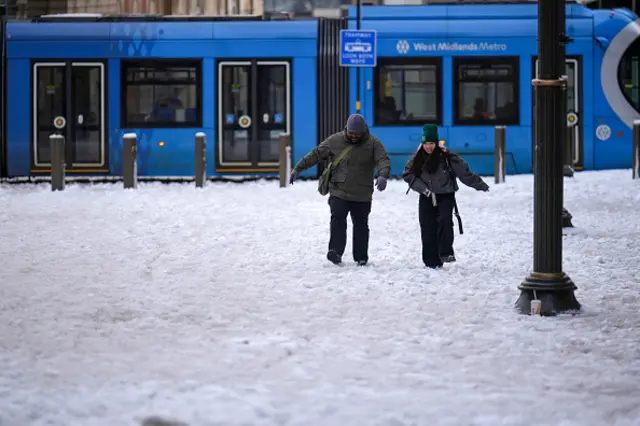People make their way through Victoria Square after overnight snow on January 09, 2026 in Birmingham, United Kingdom. Storm Gorett
