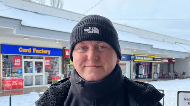 Billy Renshaw in a woolly hat and black jacket