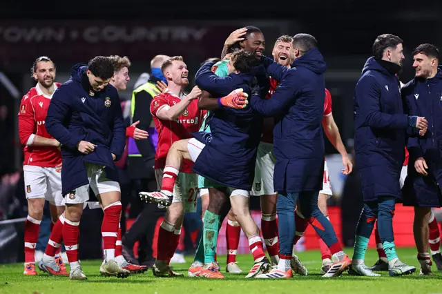 Wrexham players celebrate at full time