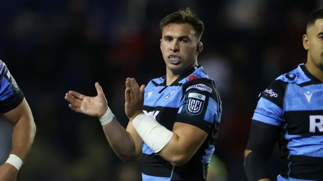Taine Basham claps while playing for Cardiff