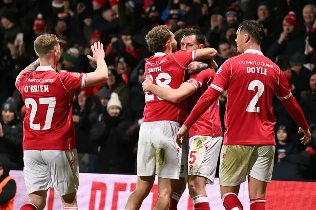 Wrexham players celebrate a goal v Forest