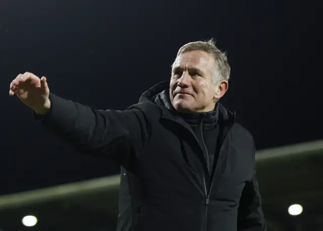 Phil Parkinson waves to fans at full time
