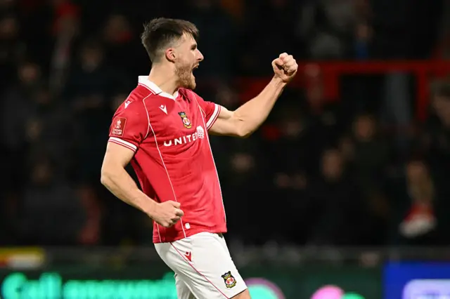 Thomason celebrates scoring his penalty in the shootout