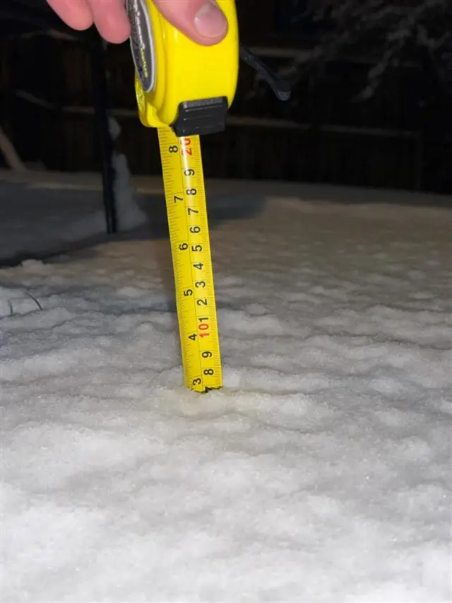 A tape measure showing three inches of snow that has fell in Derbyshire