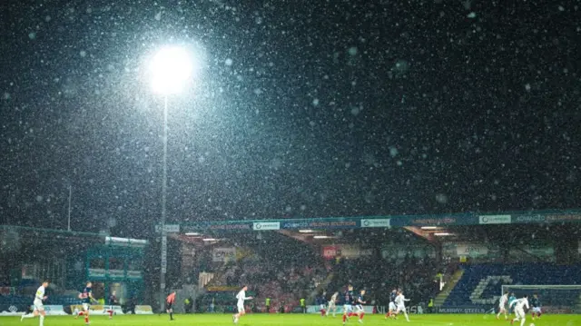 Snow falls at the Global Energy Stadium