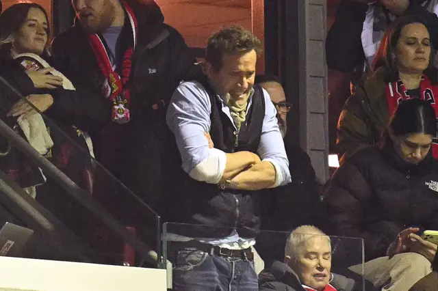 Ryan Reynolds watches on with a furrowed brow