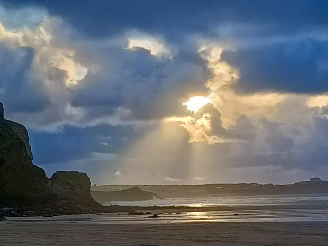 A sunset is seen over a beach in Cornwall