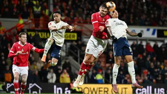Callum Doyle in action with Nottingham Forest's Igor Jesus