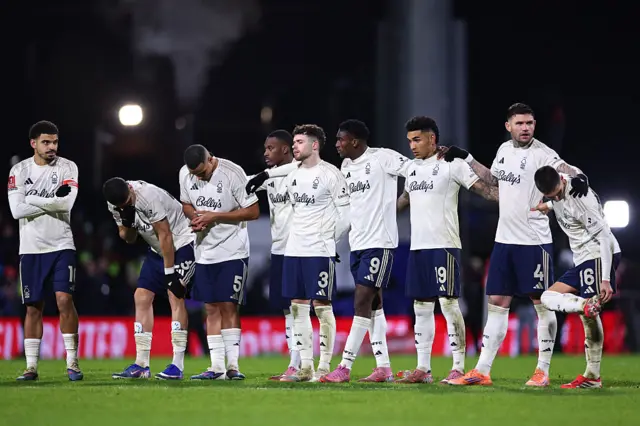 Forest players stand dejected as they prepare for penalties