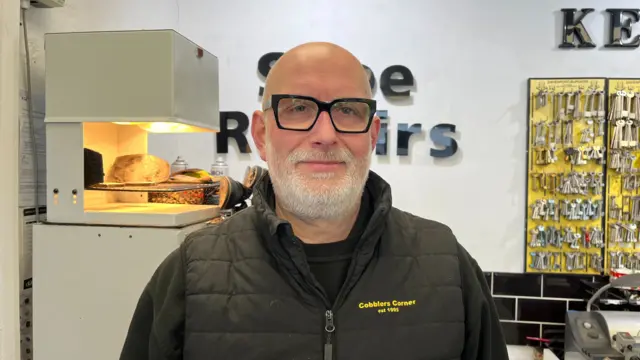 Andy Rice, wearing a black jacket and black glasses