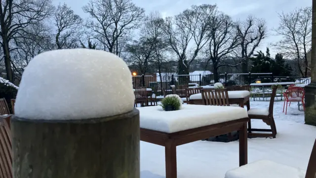 What looks like a pub beer garden covered in snow