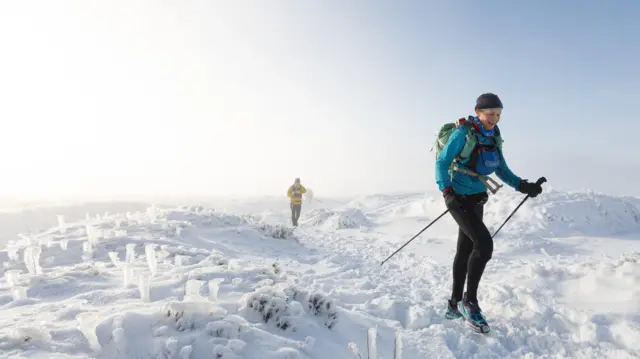 Gossage treks over snow and icy ground during the race.