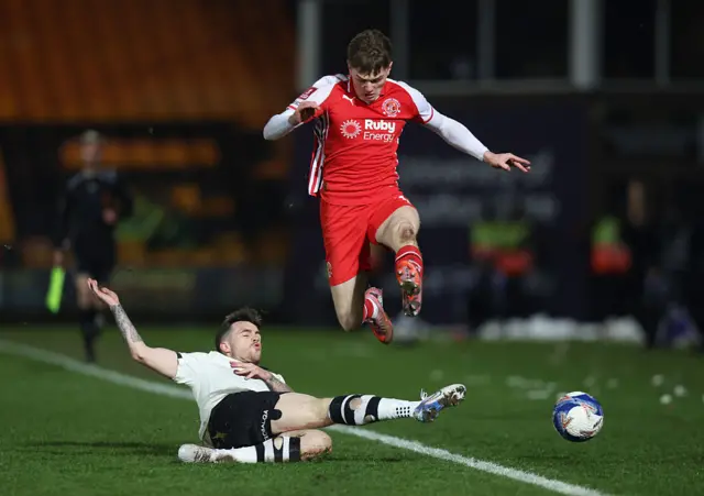 Ethan Ennis of Fleetwood Town is challenged by Mitchell Clark of Port Vale