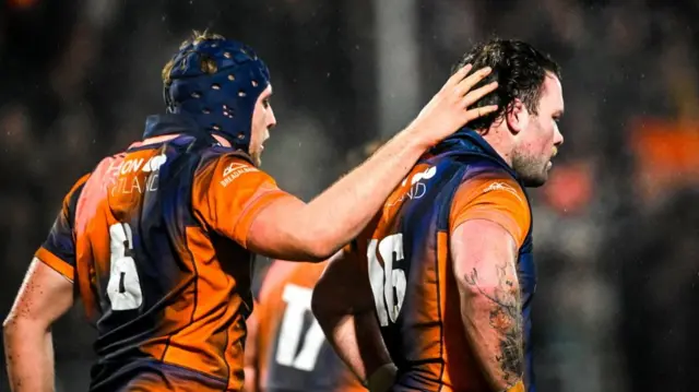 Liam McConnell congratulates Ewan Ashman
