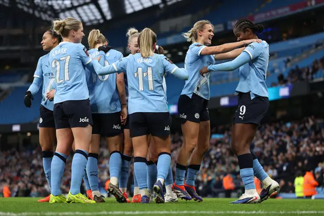 Kerstin Casparij and Khadija Shaw of Manchester City (R) celebrate after Vivianne Miedema (obscured) scored the team's fifth goal