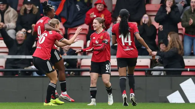 Lisa Naalsund of Manchester United celebrates scoring her team's first goal with teammates Melvine Malard, Jess Park and Jayde Riviere