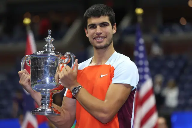 Carlos Alcaraz holds the US Open trophy