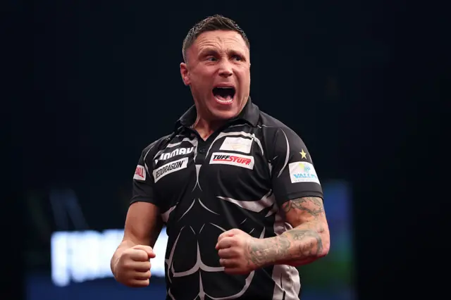 Gerwyn Price celebrates winning a leg against Luke Littler