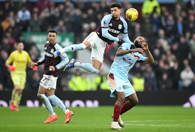 Jadon Sancho of Aston Villa contends for the aerial ball with Igor Thiago