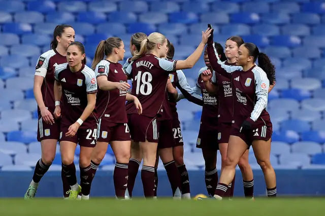 Ebony Salmon of Aston Villa (R) celebrates scoring her team's first goal with teammates