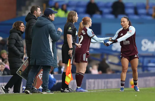 Jenna Nighswonger of Aston Villa interacts with teammate Ebony Salmon after being substituted on for teammate Rachel Maltby