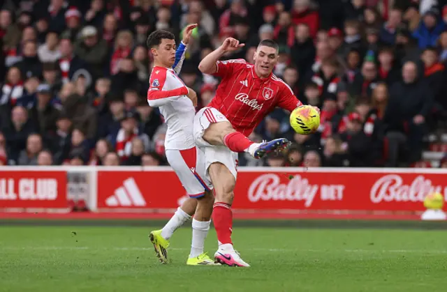 Nikola Milenkovic of Nottingham Forest is challenged by Brennan Johnson