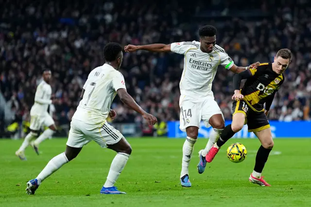 Jorge De Frutos of Rayo Vallecano battles for possession with Aurelien Tchouameni of Real Madrid