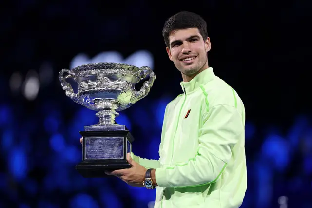 Carlos Alcaraz holds the Australian Open trophy