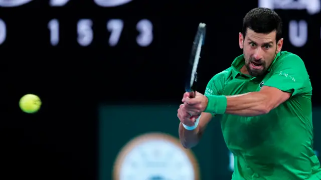 Novak Djokovic hits a backhand