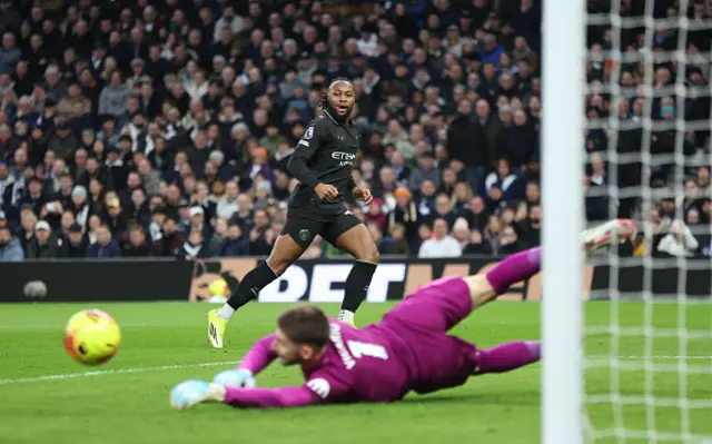 Manchester City's Antoine Semenyo sees his shot saved by Tottenham Hotspur's Guglielmo Vicario