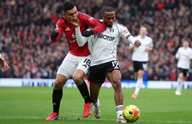 Fulham's Samuel Chukwueze in action with Manchester United's Casemiro