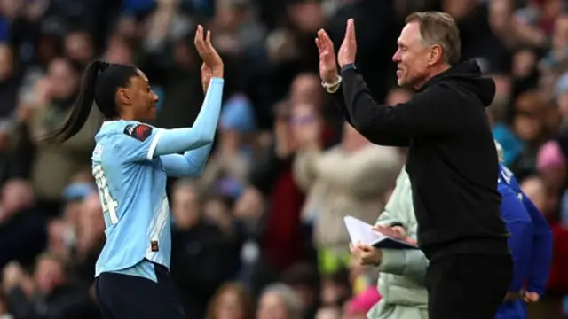 Kerolin Nicoli Israel Ferraz of Manchester City high fives Andree Jeglertz, Manager of Manchester City, as she is substituted off