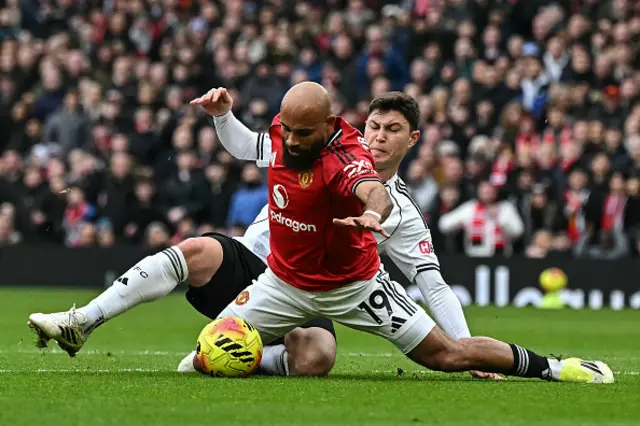 Bryan Mbeumo (front) is tackled by Fulham's Spanish defender Jorge Cuenca